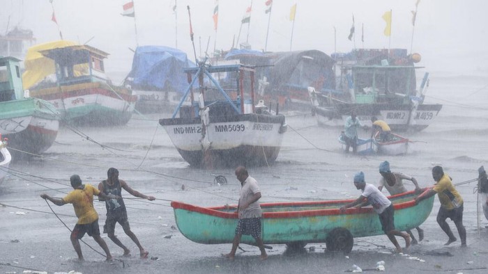 Buses are stranded on a waterlogged road during heavy rain in Mumbai, India, Monday, May 17, 2021. Cyclone Tauktae, roaring in the Arabian Sea was moving toward Indias western coast on Monday as authorities tried to evacuate hundreds of thousands of people and suspended COVID-19 vaccinations in one state. (AP Photo/Rafiq Maqbool)