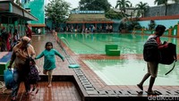 Pengunjung tampak panik saat aparat tiba. Mereka memakai pakaian seadanya dan meninggalkan kolam renang.  