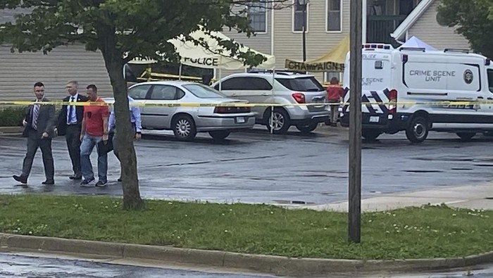 Police investigators work at the scene of a shooting in Champaign, Ill., Wednesday, May 19, 2021. (Jim Rossow/The News-Gazette via AP)
