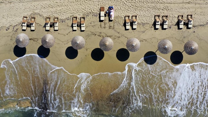 A woman swims at Agios Prokopios beach on the Aegean island of Naxos, Greece, Friday, May 14, 2021. Greece launched its tourism season Friday amid a competitive scramble across the Mediterranean to lure vacationers emerging from lockdowns. (AP Photo/Thanassis Stavrakis)