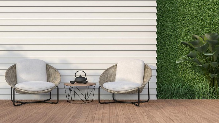 Empty wall exterior 3d render,There are white wood plank wall and wooden floor,decorate with rattan lounge chair, decorate wall with green plant.