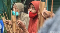 Guna mencegah penyebaran virus Corona, instruktur dan para lansia pun menerapkan protokol kesehatan, salah satunya masker saat tengah berlatih alat musik angklung.