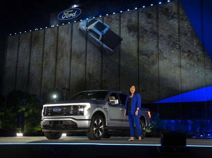 In a photo provided by Ford, Linda Zhang, F-150 Lightning chief engineer, explains details of Fords first all-electric truck at the reveal of the vehicle at Ford headquarters in Dearborn, Mich., Wednesday, May 19, 2021. the pickup will be able to travel up to 300 miles per battery charge, thanks to a frame designed to safely hold a huge lithium-ion battery that can power your house should the electricity go out. Going from zero to 60 mph (97 kilometers per hour) will take just 4.5 seconds. (Eric Perry/Ford via AP)