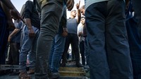 Seorang juru lelang mengambil tawaran untuk banyak ikan yang dikumpulkan para nelayan usai sejumlah kapal diizinkan kembali melaut.
