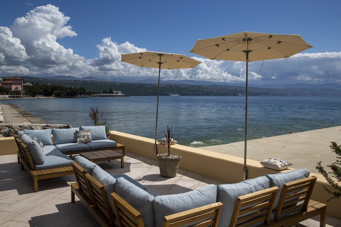 A couple sits at the seafront in Opatija, Croatia, Saturday, May 15, 2021. Croatia has opened its stunning Adriatic coastline for foreign tourists after a year of depressing coronavirus lockdowns and restrictions. (AP Photo/Darko Bandic)