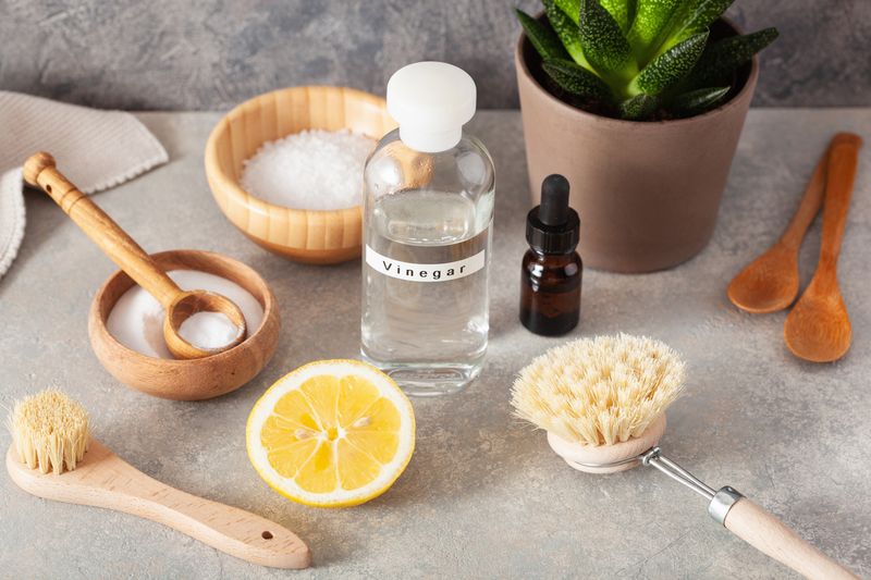 zero waste eco friendly cleaning concept. wooden brushes, lemon, baking soda, vinegar