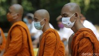 Biksu dan umat Buddha tampak khusyuk berdoa.