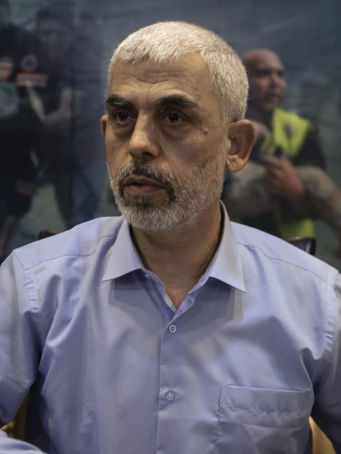 Yehiyeh Sinwar, the Palestinian leader of Hamas in the Gaza Strip, is surrounded by guards as he arrives for a meeting with foreign press, in Gaza City, Wednesday, May 26, 2021. (AP Photo/Khalil Hamra)