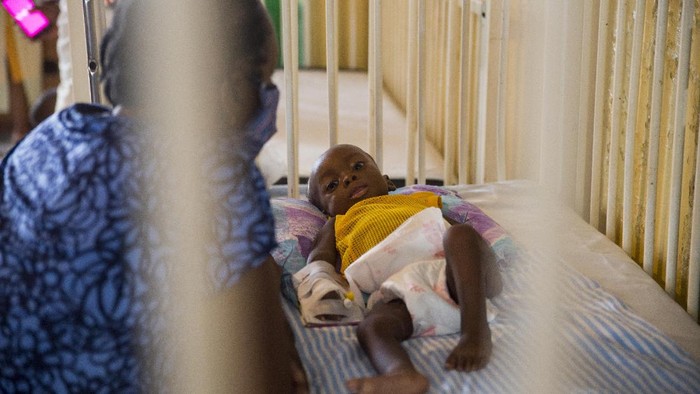 Jean Gough, UNICEF regional director for Latin America and the Caribbean, greets an infant in a malnutrition clinic in Les Cayes, Haiti, Wednesday, May 26, 2021. Gough visited the southern seaport amid concerns over an increase in malnutrition and a drop in childhood immunizations that officials blame on the coronavirus pandemic. (AP Photo/Joseph Odelyn)