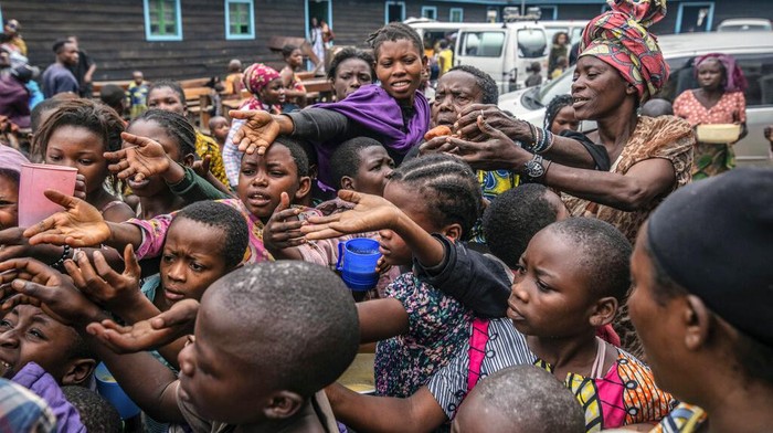 Pengungsi Gunung Berapi di Kongo Berebut Bantuan Makanan People who fled Goma, Congo, gather at a food distribution point Friday, May 28, 2021 in Sake, some 25 kms (16 miles) west of Goma where they found shelter following an official evacuation order five days after Mount Nyiragongo erupted. (AP Photo/Moses Sawasawa)