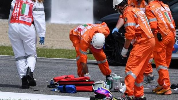 Medical officers clear the track as they evacuate Swiss Moto3 rider Jason Dupasquier in an helicopter after a crash during a qualifying session ahead the Italian Moto GP Grand Prix at the Mugello race track in Scarperia e San Piero on May 29, 2021. - Swiss Moto3 rider Jason Dupasquier was being taken to hospital after a three-bike crash that halted qualifying for the Italian motorcycling Grand Prix at Mugello on May 29, 2021. Organisers said the stricken teenager was being 