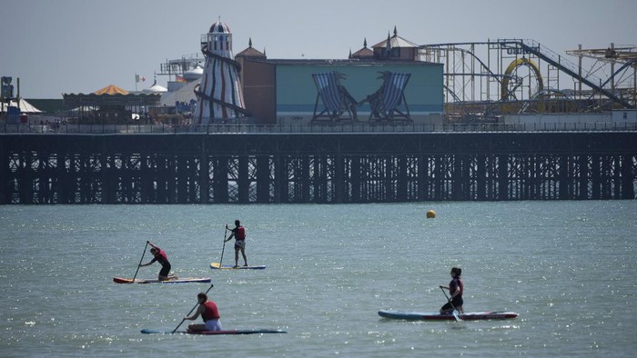 People gather during a hot day on Brighton Beach, in Brighton, on Englands south coast, Sunday, May 30, 2021. The bank holiday weekend and relaxation of Englands coronavirus restrictions has enabled many people to visit beaches, as warm weather spreads across the UK after what has been a very rainy May. (AP Photo/Matt Dunham)