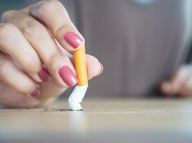 closeup woman hand destroying cigarette stop smoking concept