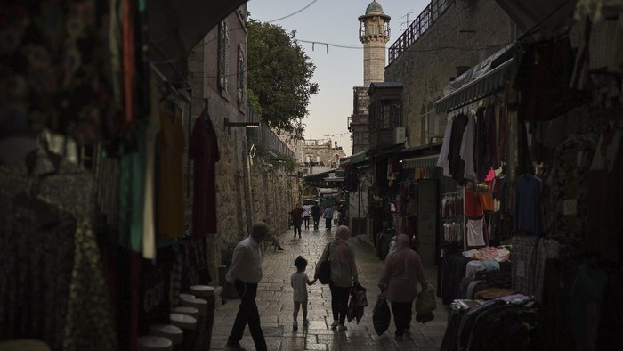Ultra-Orthodox Jewish men walk at night in Jerusalems Old City, Saturday, May 29, 2021, days after a cease-fire was reached in the 11-day war between Gazas Hamas rulers and Israel. (AP Photo/Felipe Dana)