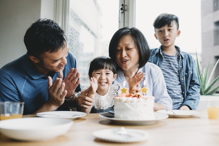 Family celebrating the birthday of the little daughter together