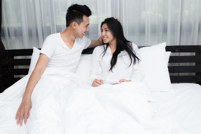 Young loving couple on the bed in the morning