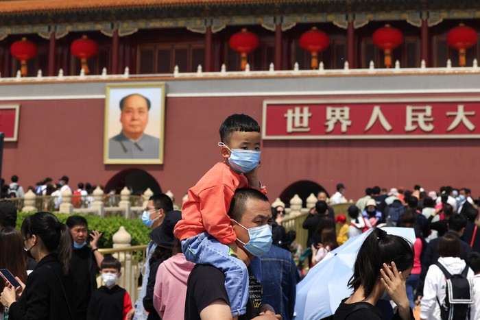 A child holds a dinosaur balloon during Childrens Day at a mall in Beijing on Tuesday, June 1, 2021. Chinas ruling Communist Party said it will ease birth limits to allow all couples to have three children instead of two in hopes of slowing the rapid aging of its population, which is adding to strains on the economy and society. (AP Photo/Ng Han Guan)
