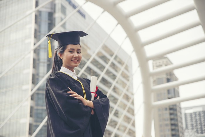 Graduate Student and Success Education in University Concept. Happy Asian student woman graduate diploma and MBA degree in asian college.