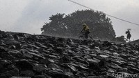 Warga beraktivitas di tengah hujan deras di Situ Gintung, Ciputat, TAngerang Selatan, Kamis (3/6/2021).