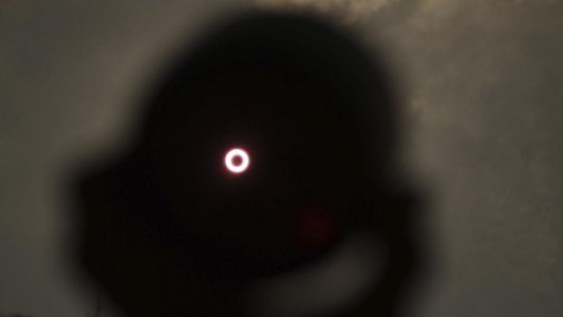 An annular solar eclipse is seen through a telescope in Siak, Riau province, Indonesia, Thursday, Thursday, Dec. 26, 2019. People along a swath of southern Asia gazed at the sky in marvel on Thursday at a 