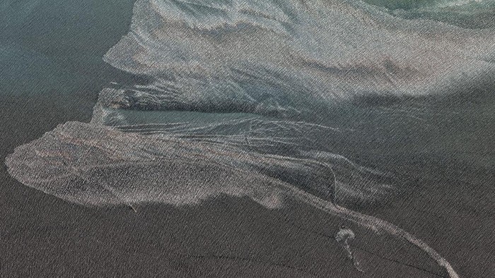 Oil-slicked waters spread out from the partially sunk Iranian navy vessel Kharg in the Gulf of Oman off the coast of Jask, Iran, in this Thursday, June 3, 2021, satellite photo from Planet Labs Inc. Satellite photographs taken Thursday show the burned hulk that remains of Iran's biggest warship after it caught fire and sank in the Gulf of Oman. (Planet Labs Inc. via AP)