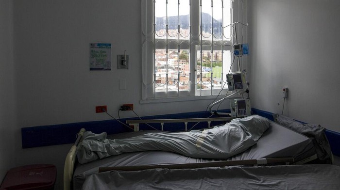 A healthcare worker tends to a COVID-19 patient in a tent set up on the soccer field of the Samaritana Hospital, in Bogota, Colombia, Thursday, June 3, 2021. Colombia has become a pandemic hotspot experiencing a third wave of COVID-19 infections and a surge in deaths. (AP Photo/Ivan Valencia)
