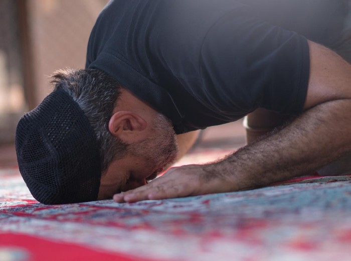 Muslim mature men prayer in mosque