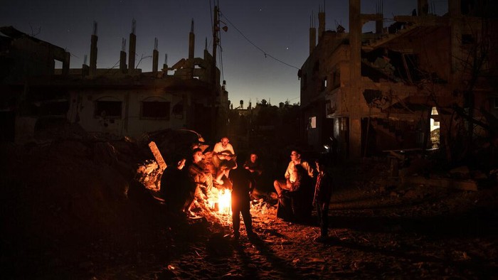 Palestinians look at the rubble of a building that collapsed after it was hit by airstrikes during an 11-day war between Gazas Hamas rulers and Israel, in Gaza City, Tuesday, June 1, 2021. (AP Photo/Felipe Dana)