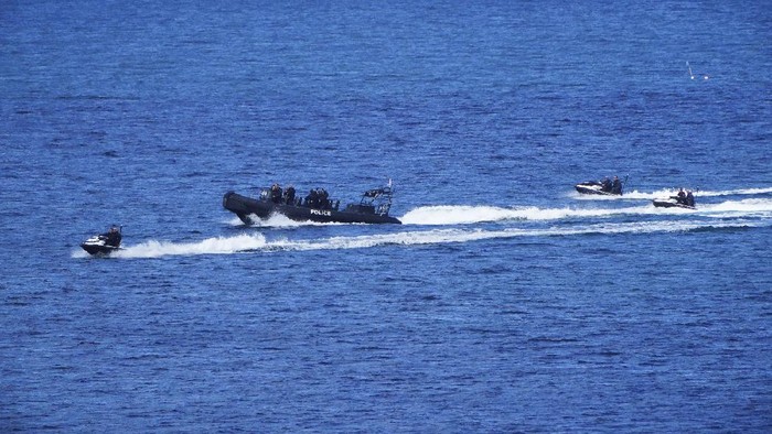 A police boat and jet skis patrols off the coast of St Ives, southern England, ahead of the upcoming G7 summit, Tuesday June 8, 2021. Three days of talks with G7 world leaders are expected to focus on global recovery from the pandemic, and a commitment to vaccinating the global population by the end of 2022. (Aaron Chown/PA via AP)
