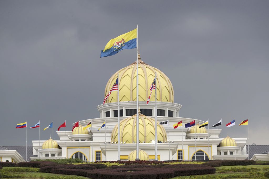 Flags fly at the Malaysia National Palace in Kuala Lumpur, Malaysia, Thursday, Jan. 24, 2019. King Sultan Muhammad V shocked the nation by announcing his abdication in January 2019, days after returning from two months of medical leave. The 49-year-old sultan from eastern Kelantan state only reigned for two years as Malaysia's 15th king and didn't give any reason for quitting. Sultan Abdullah Azlan Shah succeeded his ailing 88-year-old father on Jan. 15, in a move seen as paving the way for him to become the next king. (AP Photo/Vincent Thian)