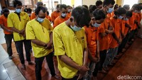 Mereka masing-masing meminta uang dari para sopir truk kontainer yang lewat.