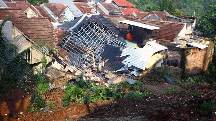 Warga memantau arus aiir yang masuk dan menyebabkan banjir di perumahannya akibat jebolnya tanggul karena tertimpa tanah longsor, di Perumahan Nerada Estate Ciputat, Tangerang Selatan, Banten, Sabtu (12/6/2021). Longsor yang menimpa sejumlah rumah disebabkan hujan deras yang terus menerus di kawasan tersebut dan tidak ada korban jiwa dalam peristiwa itu. ANTARA FOTO/Muhammad Iqbal/hp.