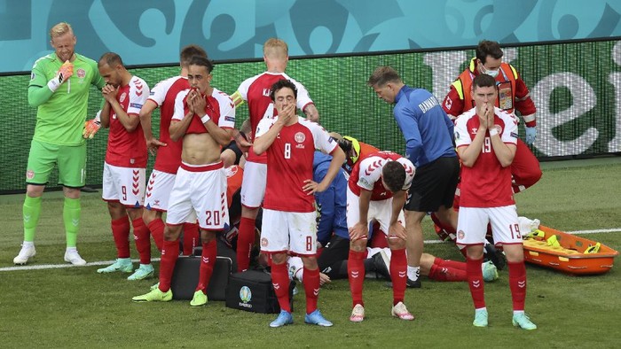 Eriksen Denmarks players react as their teammate Christian Eriksen lays injured on the ground during the Euro 2020 soccer championship group B match between Denmark and Finland at Parken stadium in Copenhagen, Denmark, Saturday, June 12, 2021. (Wolfgang Rattay/Pool via AP)