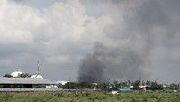 Asap hitam terlihat terlihat mulai menghilang sesaat sebelum api berhasil dipadamkan, di Kilang Pertamina RU IV Cilacap, Jawa Tengah, Minggu (13/6/2021).