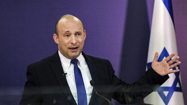 FILE - In this June 6, 2021, file photo, Naftali Bennett, Israeli parliament member from the Yamina party, gives a statement at the Knesset, Israel's parliament, in Jerusalem. If all goes according to plan, Israel will swear in a new government on Sunday, June 13, putting an end to Prime Minister Benjamin Netanyahu’s record 12-year rule and a political crisis that led to four elections in less than two years. The next government, which will be led by the ultranationalist Bennett, has vowed to chart a new course aimed at healing the country’s divisions and restoring a sense of normalcy.  (Menahem Kahana/Pool via AP, File)
