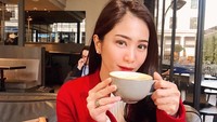 Momen ngopi cantik di sebuah kafe juga pernah dibagikan oleh Bunga. Tampak cantik dengan coat merah, ia menikmati secangir latte. Foto: Instagram @bungazainal05