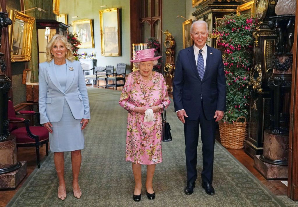 WINDSOR, ENGLAND - JUNE 13:   First Lady Jill Biden, Queen Elizabeth II and US President Joe Biden view the ranks of a Guard of Honour formed of The Queen's Company First Battalion Grenadier Guards at Windsor castle on June 11, 2021 in Windsor, England.  Queen Elizabeth II hosts US President, Joe Biden and First Lady, Dr Jill Biden, at Windsor Castle. The President arrived from Cornwall where he attended the G7 Leader's Summit and will travel on to Brussels for a meeting of NATO Allies and later in the week he will meet President of Russia, Vladimir Putin. (Photo by Richard Pohle-WPA Pool/Getty Images)
