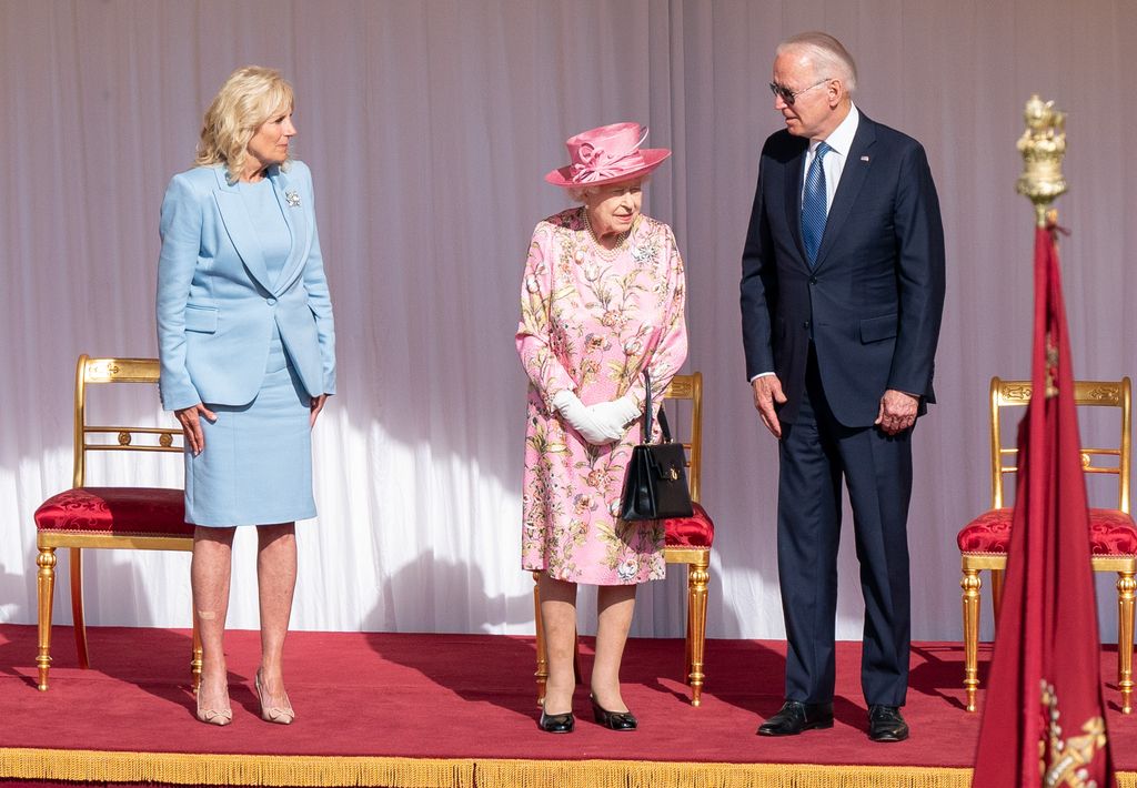 WINDSOR, ENGLAND - JUNE 13:   First Lady Jill Biden, Queen Elizabeth II and US President Joe Biden view the ranks of a Guard of Honour formed of The Queen's Company First Battalion Grenadier Guards at Windsor castle on June 11, 2021 in Windsor, England.  Queen Elizabeth II hosts US President, Joe Biden and First Lady, Dr Jill Biden, at Windsor Castle. The President arrived from Cornwall where he attended the G7 Leader's Summit and will travel on to Brussels for a meeting of NATO Allies and later in the week he will meet President of Russia, Vladimir Putin. (Photo by Richard Pohle-WPA Pool/Getty Images)