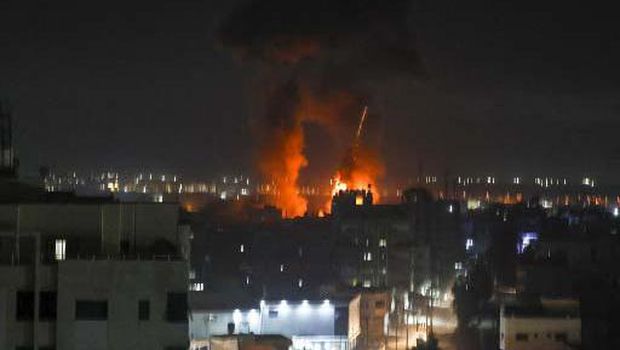 Explosions light-up the night sky at Khan Yunis in the southern Gaza Strip, as Israeli forces shell the Palestinian enclave, early on June 16, 2021. (Photo by SAID KHATIB / AFP)
