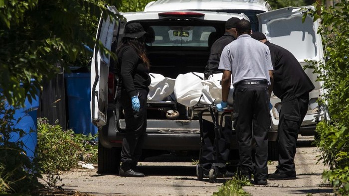 Police tape marks off a Chicago street as officers investigate the scene of a fatal shooting in the city's South Side on Tuesday, June 15, 2021. An argument in a house erupted into gunfire early Tuesday, police said. (AP Photo/Teresa Crawford)