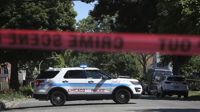 Police tape marks off a Chicago street as officers investigate the scene of a fatal shooting in the citys South Side on Tuesday, June 15, 2021. An argument in a house erupted into gunfire early Tuesday, police said. (AP Photo/Teresa Crawford)