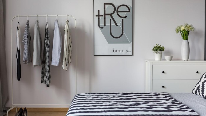 Collection of female clothes hanging on rack in dressing room