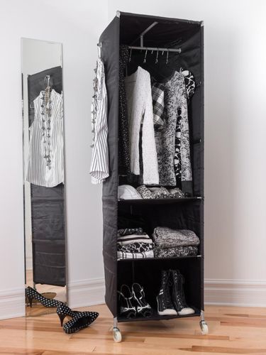 Mobile clothes organizer with black and white clothing and shoes.