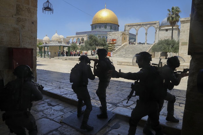 Masked Palestinians wearing the Palestinian flag during clashes with Israeli security forces stand n front of the Dome of the Rock Mosque at the Al Aqsa Mosque compound in Jerusalems Old City, Friday, June 18, 2021. Hundreds demonstrated after Friday prayers in response to a rally held by Jewish ultranationalists on Tuesday in which dozens had chanted 
