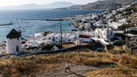 Yunani tak hanya punya Santorini, ada pula Mykonos yang terkenal karena bangunan-bangunan di kawasan itu didominasi warna putih. Mykonos adalah pulau tandus yang menonjol tinggi serta dikelilingi oleh bebatuan dan pepohona khas yang sering dijumpai di daerah mediterania semacam agave yang besar-besar hingga deretan pohon zaitun. Bangunan-bangunan yang ada di Mykonos seperti mengitari pulau sehingga terkesan berbentuk terasering dan jalinan gang-gang atau jalan kecil untuk pejalan kaki menuju ke pusat tujuan wisata. Byron Smith/Getty Images.