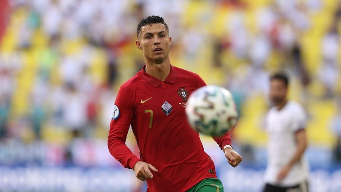 Cristiano Ronaldo MUNICH, GERMANY - JUNE 19: Cristiano Ronaldo of Portugal runs with the ball during the UEFA Euro 2020 Championship Group F match between Portugal and Germany at Football Arena Munich on June 19, 2021 in Munich, Germany. (Photo by Alexander Hassenstein/Getty Images)