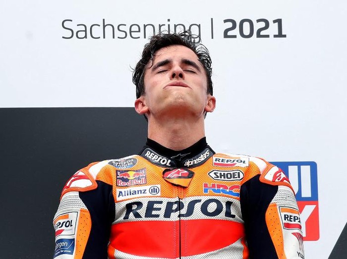 Honda Spanish rider Marc Marquez celebrates on the podium after winning the German MotoGP Grand Prix at the Sachsenring racing circuit in Hohenstein-Ernstthal near Chemnitz, eastern Germany, on June 20, 2021. (Photo by Ronny HARTMANN / AFP)