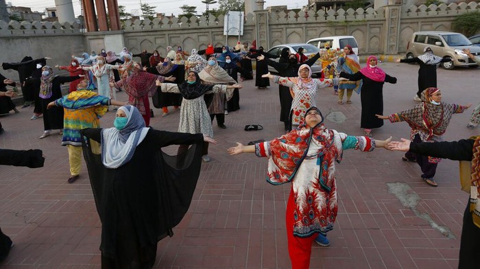 People take part in yoga session at outer area of the historical Shalimar Garden, in Lahore, Pakistan, Sunday, June 20, 2021. The International Yoga Day has been celebrated annually on June 21. (AP Photo/K.M. Chaudary)