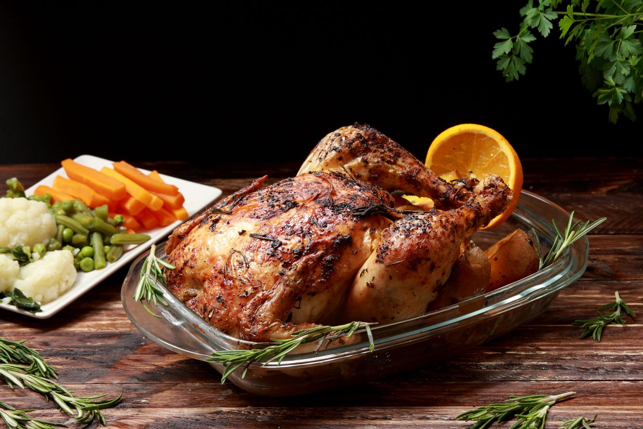 Traditional English Roast Chicken marinated with Herbs and Spices served with Roast Potatoes and Vegetables as a side dish