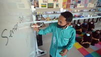 Seorang santri mengoperasikan robot Sabai menggunakan remote di kafe Arfa, Perguruan Diniyyah Putri Padangpanjang, Sumatera Barat.